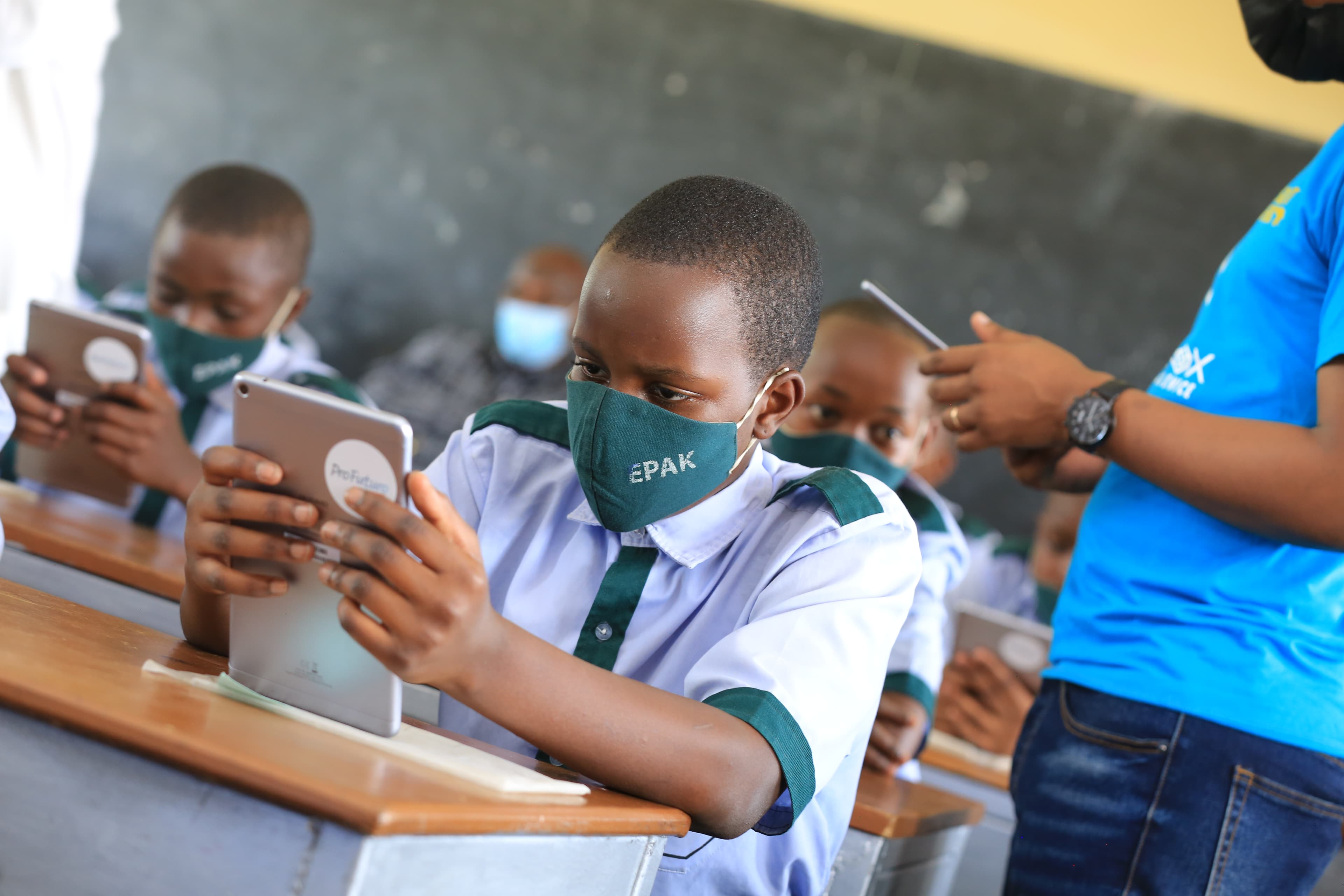 A young student using SomaBox web interface on a tablet