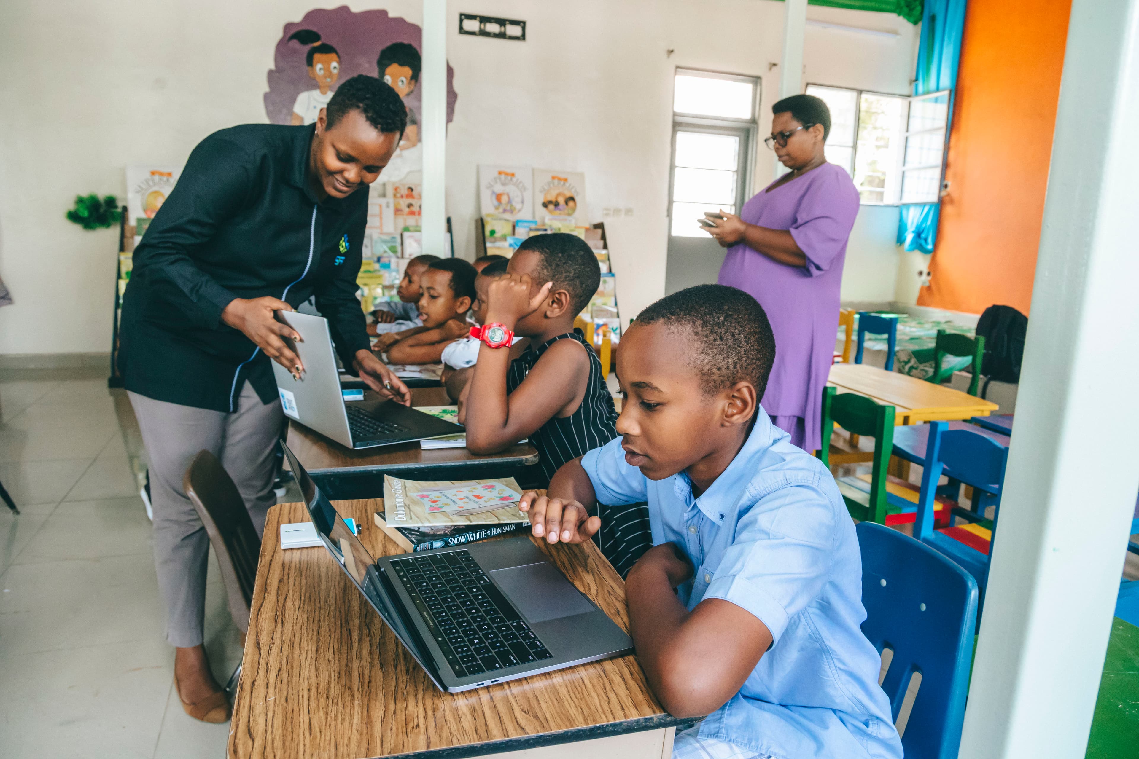 Soma Foundation Rwanda team showing students how to use SomaBox