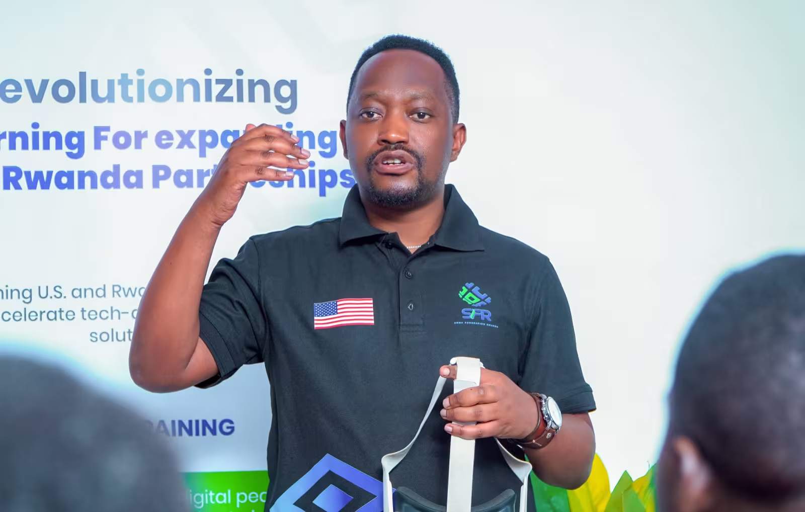 A Soma Foundation Rwanda facilitator presenting a VR headset at the SomaBox teacher training