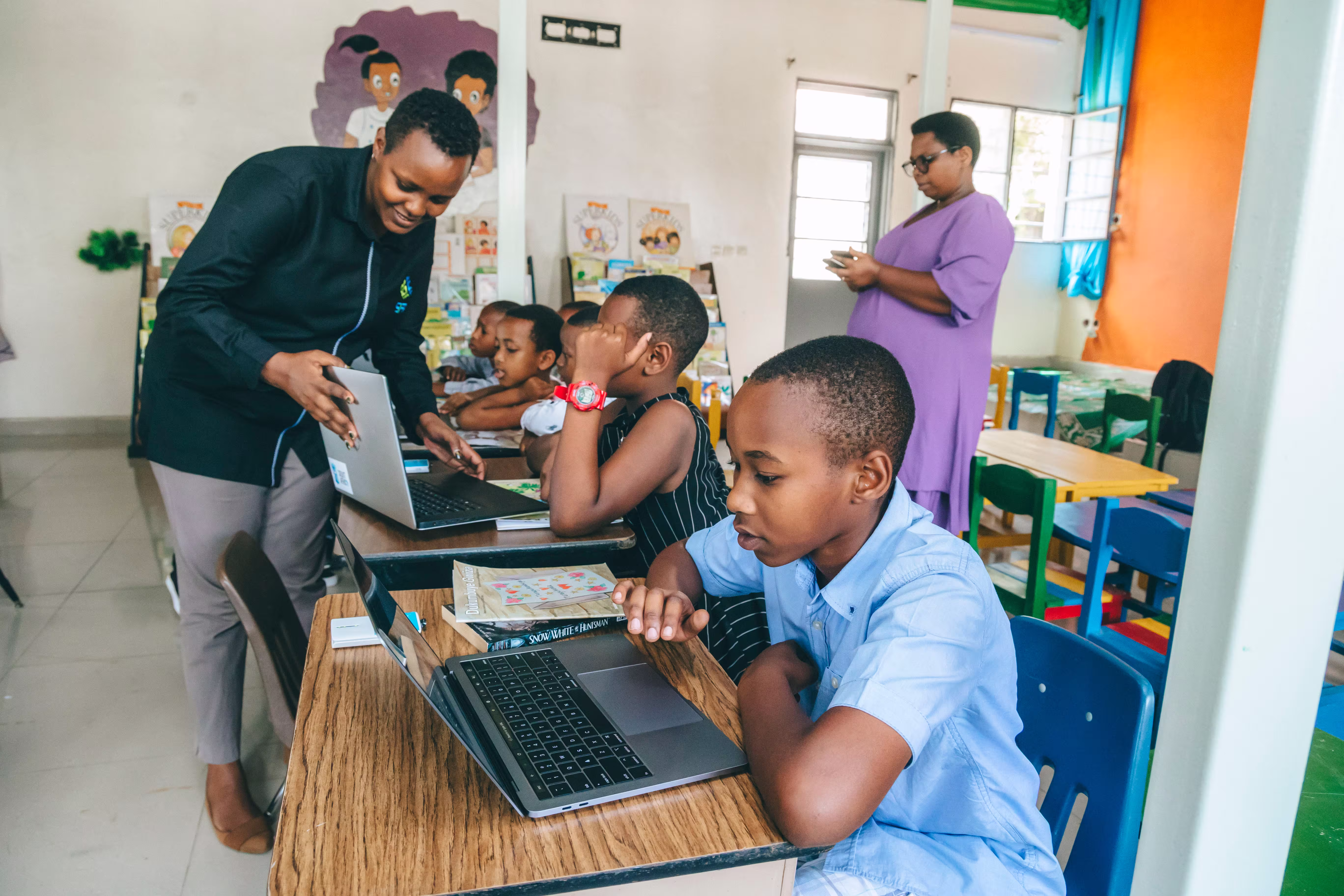 Soma Foundation Rwanda team showing students how to use SomaBox